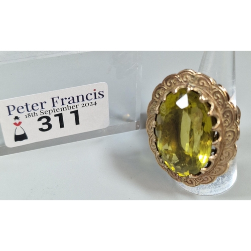 311 - 9ct gold green stone dress ring of large oval form. 21.5g approx. Size L1/2. (B.P. 21% + VAT)