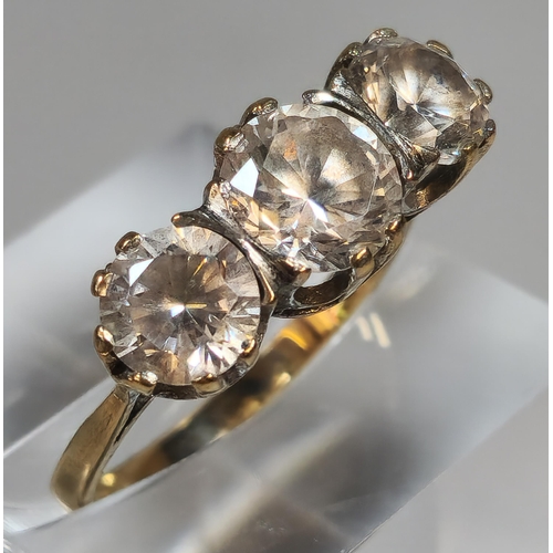 313 - 9ct gold clear three stone dress ring. 3.4g approx. Size O. (B.P. 21% + VAT)