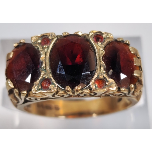 316 - 9ct gold garnet three stone dress ring. 4.1g approx. Size N1/2. (B.P. 21% + VAT)