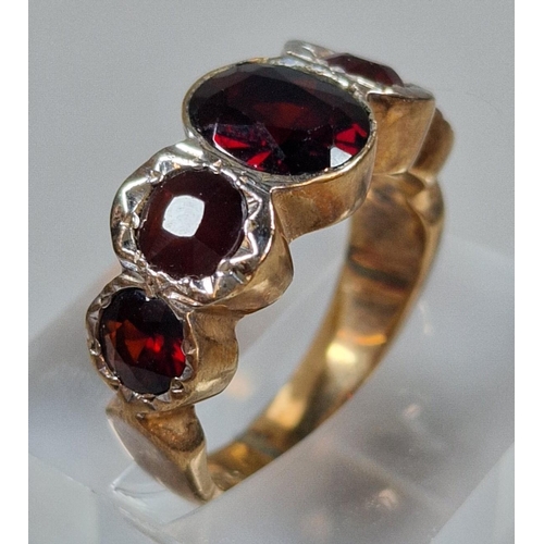 318 - 9ct gold red five stone dress ring, one stone missing. 7.8g approx. Size O. (B.P. 21% + VAT)