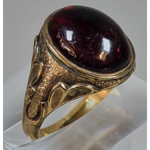 320 - Yellow metal and red cabochon stone dress ring, un-marked. 5g approx. size N1/2. (B.P. 21% + VAT)