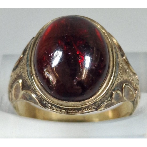 320 - Yellow metal and red cabochon stone dress ring, un-marked. 5g approx. size N1/2. (B.P. 21% + VAT)