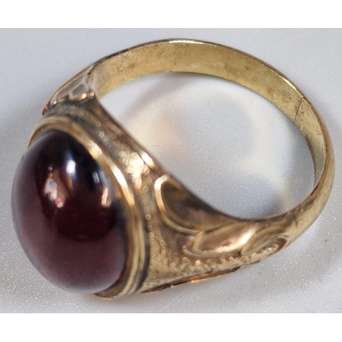 320 - Yellow metal and red cabochon stone dress ring, un-marked. 5g approx. size N1/2. (B.P. 21% + VAT)