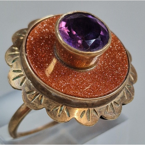 322 - 9ct gold modernist design purple stone dress ring. 9.5g approx. Size Q1/2. (B.P. 21% + VAT)