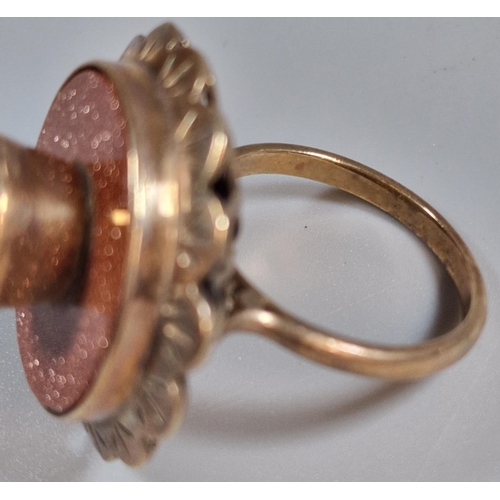 322 - 9ct gold modernist design purple stone dress ring. 9.5g approx. Size Q1/2. (B.P. 21% + VAT)