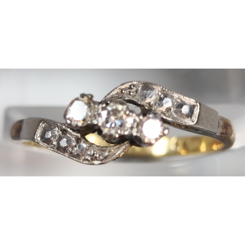 329 - 18ct gold and platinum diamond three stone twist shank ring. 2.3g approx. Size N. (B.P. 21% + VAT)