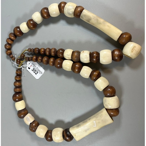 352 - Two vintage wooden and bone African graduated necklaces.  (2) (B.P. 21% + VAT)