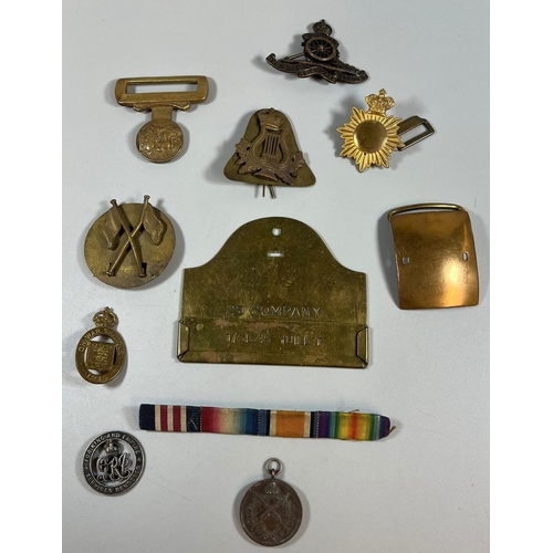 358 - Plastic box of military cap badges: Services Rendered, Shooting Medal 1945, belt buckles etc. (B.P. ... 