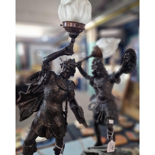 390 - Pair of spelter table lamps in the form of Vikings with flambe glass shades. (2) (B.P. 21% + VAT)