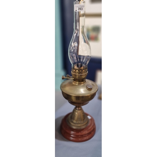 393 - Early 20th century double oil burner lamp, having brass reservoir on brass and ceramic moulded base.... 