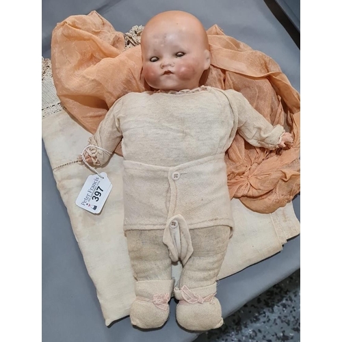 397 - Armand and Marseille German bisque headed doll in appearing original clothing with rolling glass eye... 