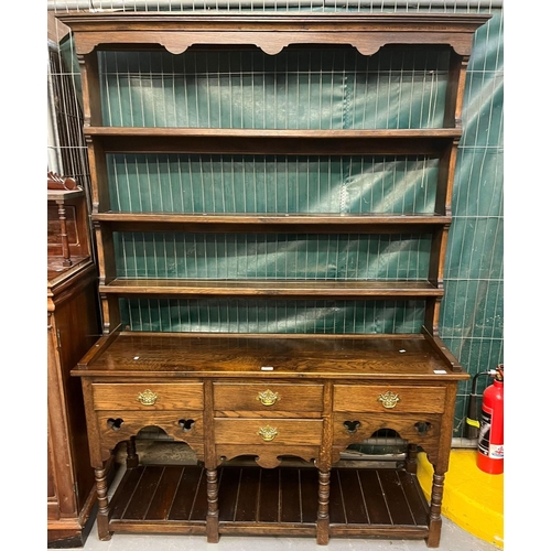 425 - Reproduction Welsh oak rack backed dresser with Gothic style decoration, three shelves to the open r... 