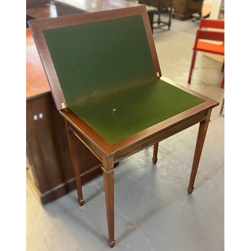 427 - Edwardian mahogany rectangular shaped fold over card table on square legs with spade feet. 70cm wide... 