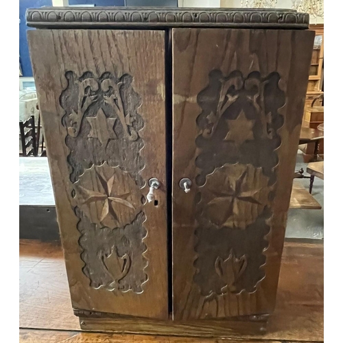 435 - Small carved oak specimen cupboard with two doors and fitted compartments. 32cm wide approx.(B.P. 21... 