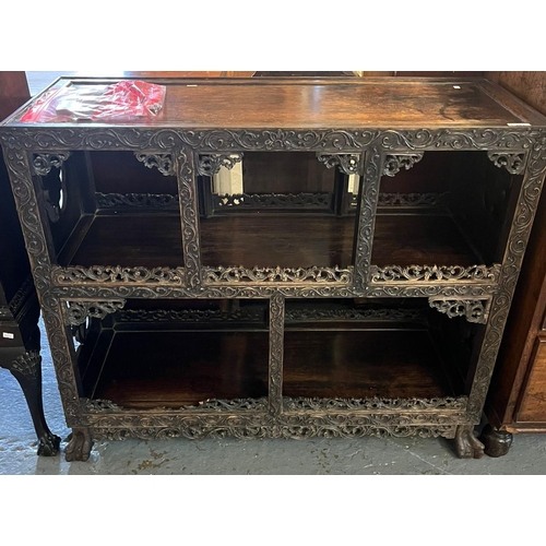 451 - Chinese carved hardwood shelf unit with overall foliate moulded and pierced framing on fluted feet. ... 