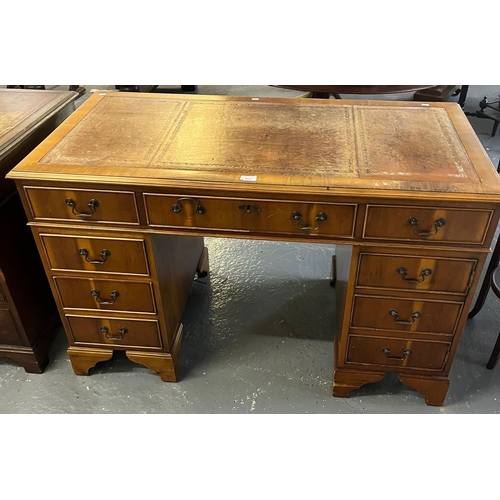 475 - Reproduction yew finish pedestal desk with inset leather writing surface, cock beaded drawers and br... 