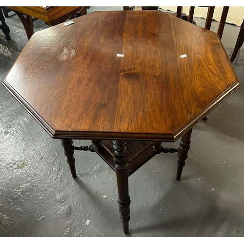 492 - Edwardian octagonal mahogany centre table on ring turned under-frame with under-tier. 68cm wide appr... 