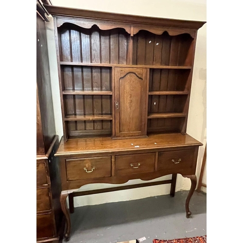 507 - 20th century oak dresser, having boarded rack back with centre cupboard, the base with moulded edge ... 