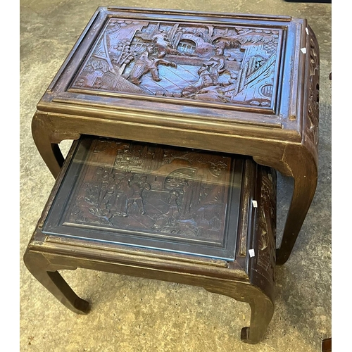 536 - Nest of two graduated Chinese carved occasional tables with inset glass tops. (B.P. 21% + VAT)