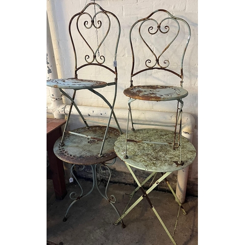 542 - Two French style circular metal cafe tables with a pair of metal framed folding chairs. (4) (B.P. 21... 