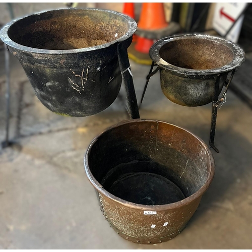 543 - Two cast metal planters on three legs, together with a copper bowl. (3) (B.P. 21% + VAT)