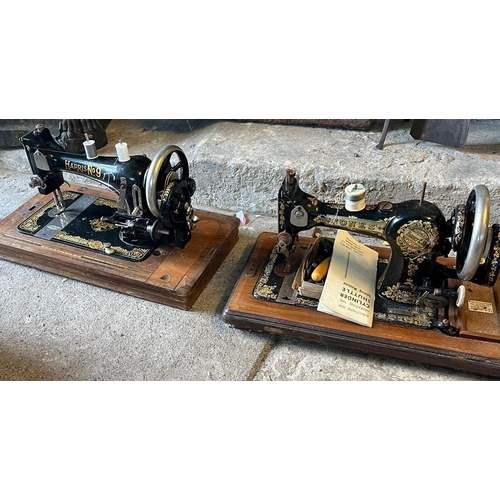 550 - Three hand sewing machines with wooden covers. (3)