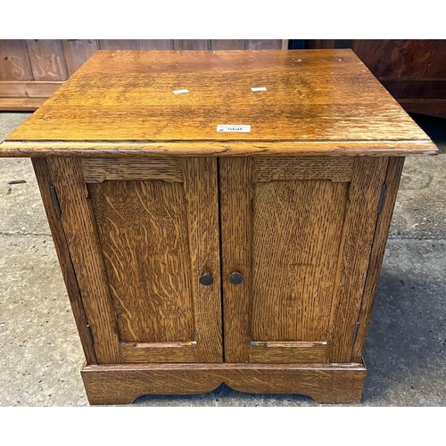 560 - Useful two door oak low cupboard/occasional table. 48cm wide approx. (B.P. 21% + VAT)