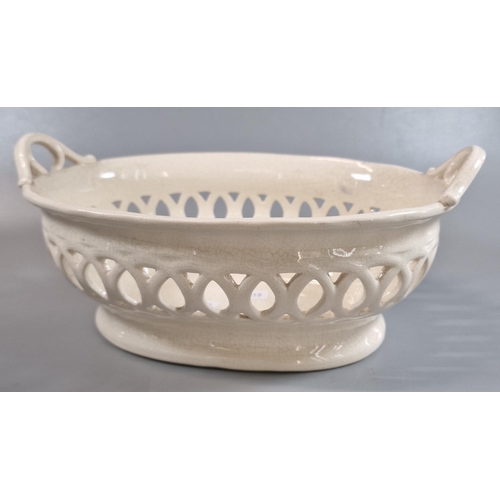 76 - 19th century Llanelly Pottery cream ground chestnut basket, the two shaped handles above a pierced r... 