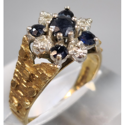 194 - 9ct gold blue and clear stone cluster ring. 4.2g approx. Size L. (B.P. 21% + VAT)