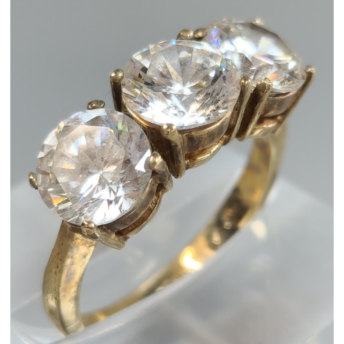 196 - 9ct gold three stone cubic zirconia dress ring. 4.5g approx. Size M. (B.P. 21% + VAT)