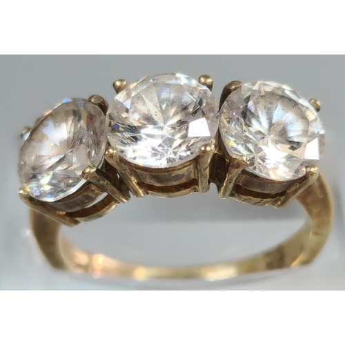 196 - 9ct gold three stone cubic zirconia dress ring. 4.5g approx. Size M. (B.P. 21% + VAT)