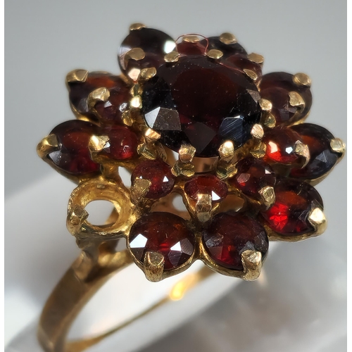 197 - 9ct gold garnet multi cluster flowerhead ring (one stone missing). 5.3fg approx. Size M. (B.P. 21% +... 