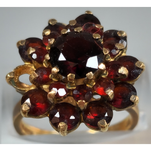 197 - 9ct gold garnet multi cluster flowerhead ring (one stone missing). 5.3fg approx. Size M. (B.P. 21% +... 