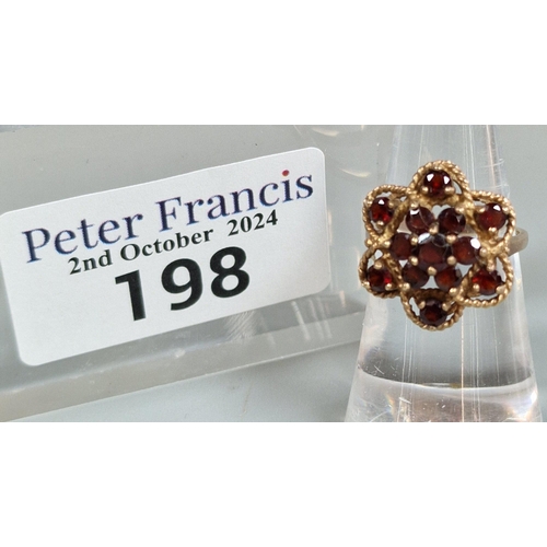 198 - 9ct gold garnet multi cluster flowerhead ring. 4.1g approx. Size K. (B.P. 21% + VAT)