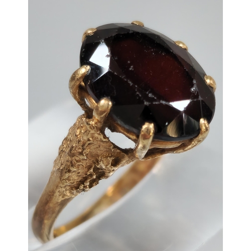 200 - 9ct gold red stone dress ring. 3.5g approx. Size K1/2. (B.P. 21% + VAT)