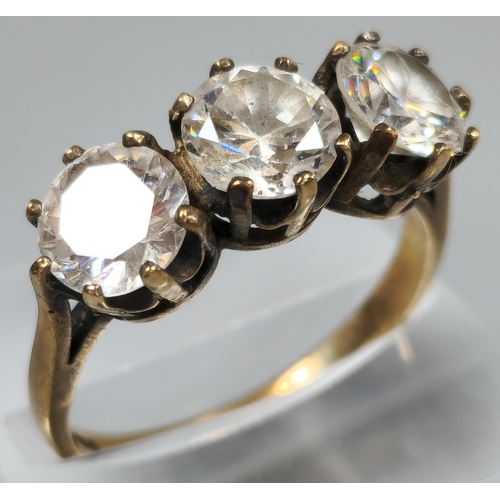 203 - 9ct gold clear three stone dress ring. 3.9g approx. Size P1/2. (B.P. 21% + VAT)