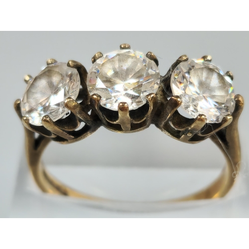 203 - 9ct gold clear three stone dress ring. 3.9g approx. Size P1/2. (B.P. 21% + VAT)