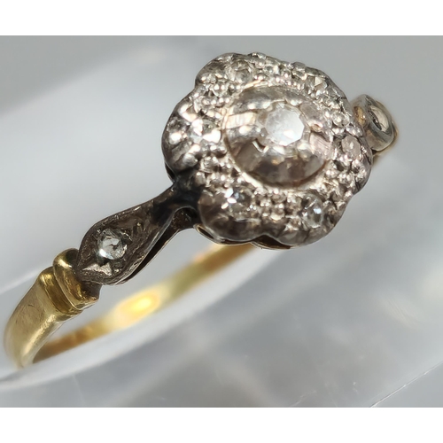 205 - 18ct gold and platinum diamond flowerhead ring. 1.7g Size I1/2. (B.P. 21% + VAT)