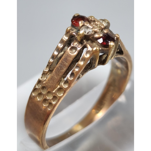 211 - 9ct gold red and clear stone dress ring. 3.2g approx. Size P. (B.P. 21% + VAT)