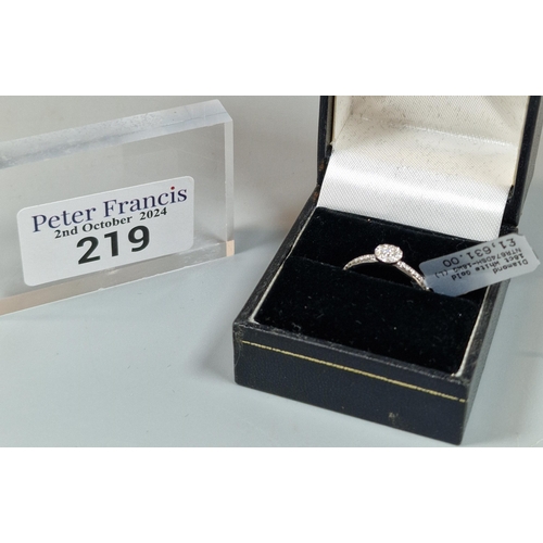 219 - Diamond 18ct white gold solitaire ring with tiny diamond chips to each shoulder. In ring box. 2.3g a... 