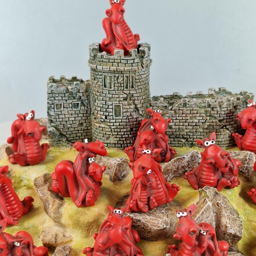 22 - Modern resin and composition 'Dragonworld' castle sculpture with rock work and novelty dragons. (B.P... 