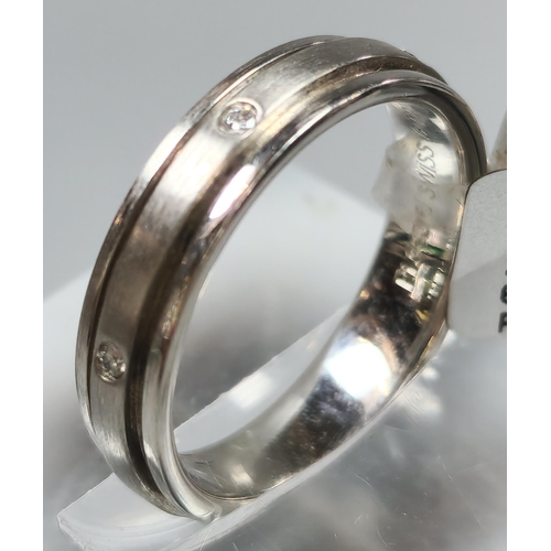 220 - Diamond and platinum wedding band. In ring box. 7g approx. Size L. (B.P. 21% + VAT)