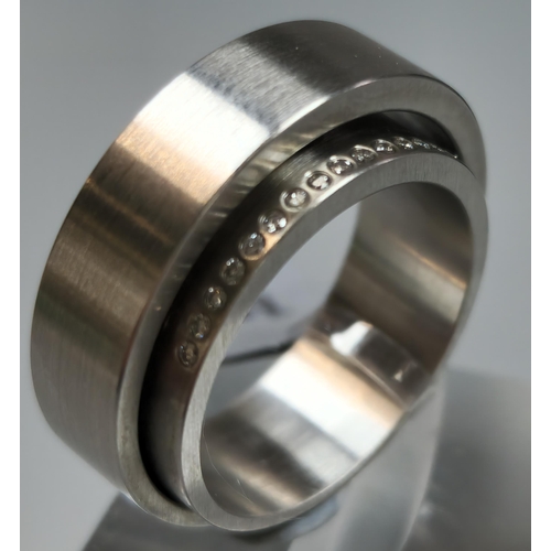 221 - Unusual diamond and stainless steel modernist ring. In 'Wave' ring box. Size M. (B.P. 21% + VAT)