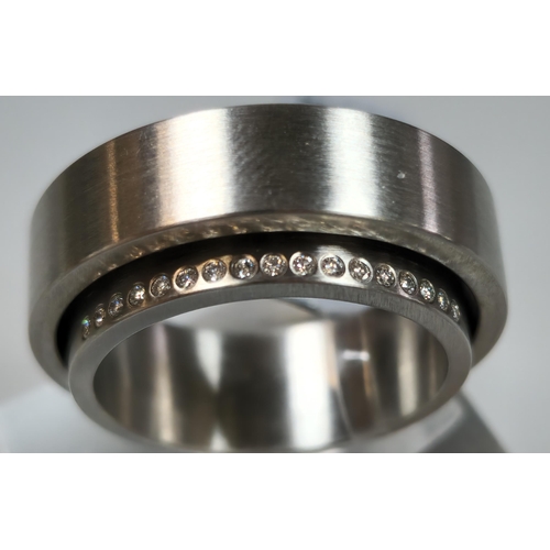 221 - Unusual diamond and stainless steel modernist ring. In 'Wave' ring box. Size M. (B.P. 21% + VAT)