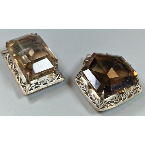 236 - Two similar brown stone faceted pendants in white metal mounts. (B.P. 21% + VAT)