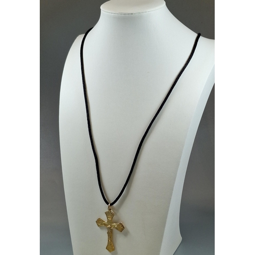 237 - Gilt sterling silver crucifix pendant on black silk chain.  (B.P. 21% + VAT)