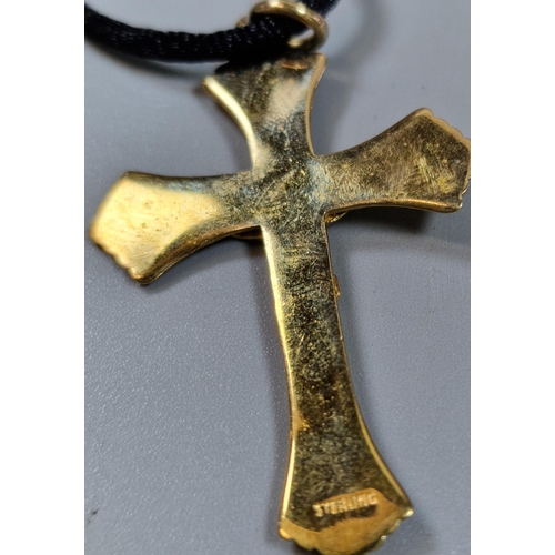 237 - Gilt sterling silver crucifix pendant on black silk chain.  (B.P. 21% + VAT)