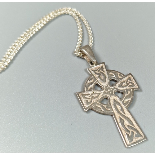 243 - Celtic design silver cross pendant with silver chain.  (B.P. 21% + VAT)