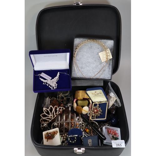 265 - Suitcase of oddments to include: silver plated toast rack, various jewellery including brooches, nec... 