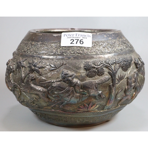 276 - Indian/Burmese circular bowl, chased in bold relief with a hunting party under attack with various a... 